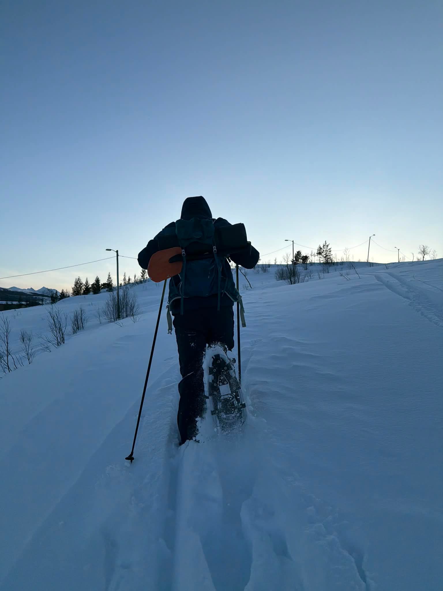Snowshoeing at dusk with the Arctic sky above